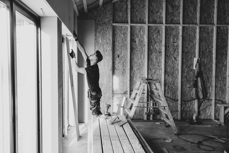 Contractor installing custom kitchen cabinets